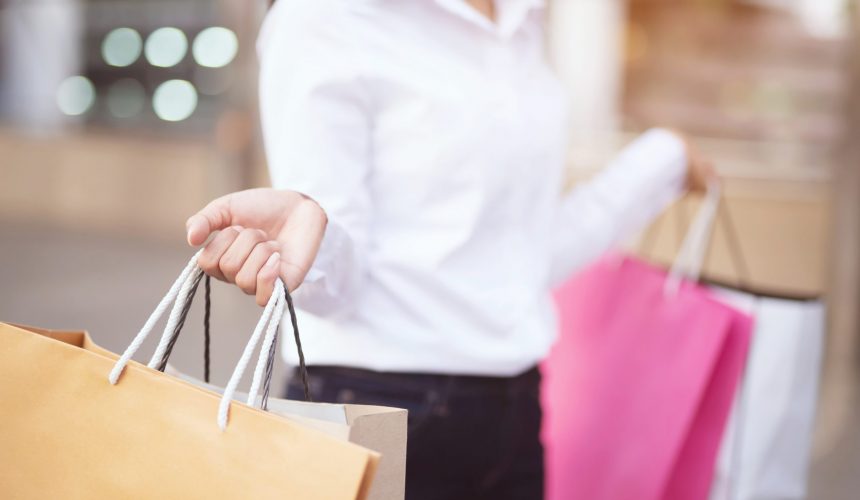 Close up of consumerism young woman holding hand many shopping bag in fashion boutique after buying presents while walking along the street with copy space , enjoying summer sale and people concept Close up of consumerism young woman holding hand many shopping bag in fashion boutique after buying presents while walking along the street with copy space , enjoying summer sale and people concept